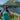 Woman wearing Rock Life teal tank top on grassy hillside overlooking blue lake and mountains in Kodiak, Alaska – island life apparel and adventure gear