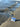 Rock Life sticker placed on a sandy beach near ocean waves- durable Alaska themed vinyl sticker for island life and adventure gear.