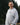 Smiling person outdoors wearing gray Campfire Nights hoodie with Rock Life mountain logo, casual sweatshirt for hiking, camping, and outdoor adventures