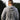 Back view of man outdoors wearing gray Campfire Nights hoodie with mountain and campfire graphic, casual sweatshirt for camping, hiking, and outdoor adventures