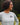 Side view of woman outdoors wearing Campfire Nights long sleeve tee with Rock Life mountain logo, casual camping and hiking shirt for outdoor adventures