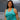 Woman wearing a teal Campfire Nights tank top with campfire graphic design, inspired by Kodiak island life and outdoor adventures, casual summer apparel