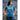 Woman wearing teal Wake Up Rock Life Repeat t-shirt on rocky Kodiak Alaska shore – island lifestyle and adventure apparel