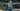 Child wearing green Adventure in Every Letter youth hoodie with arms outstretched in Kodiak, Alaska